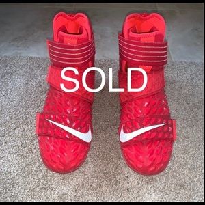 Men’s red/white NIKE football cleats size 10.